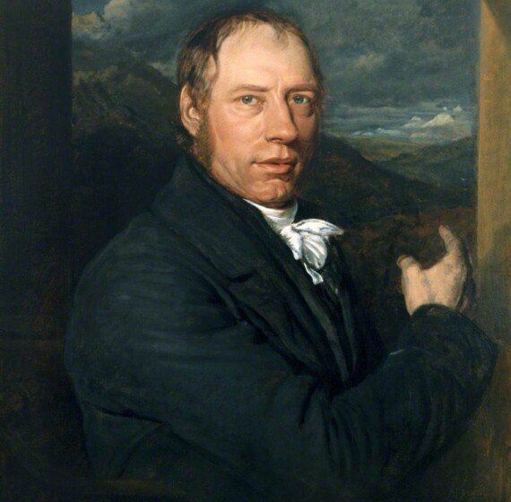 Second Stop: London. Catch Me Who Can 5 A classic oil painting portrait of Richard Trevithick. He is depicted as a middle-aged man with fair skin, light brown hair, and blue eyes, looking directly at the viewer. He wears a dark navy blue coat over a white shirt with a tied cravat. He is gesturing with his right hand toward a dramatic landscape in the background, featuring rolling hills under a dark, cloudy sky.